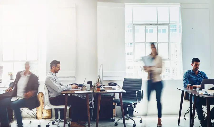 A diverse group of professionals collaborating in a modern office environment.